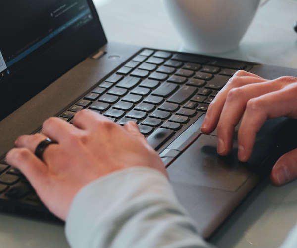 Hands on a laptop keyboard