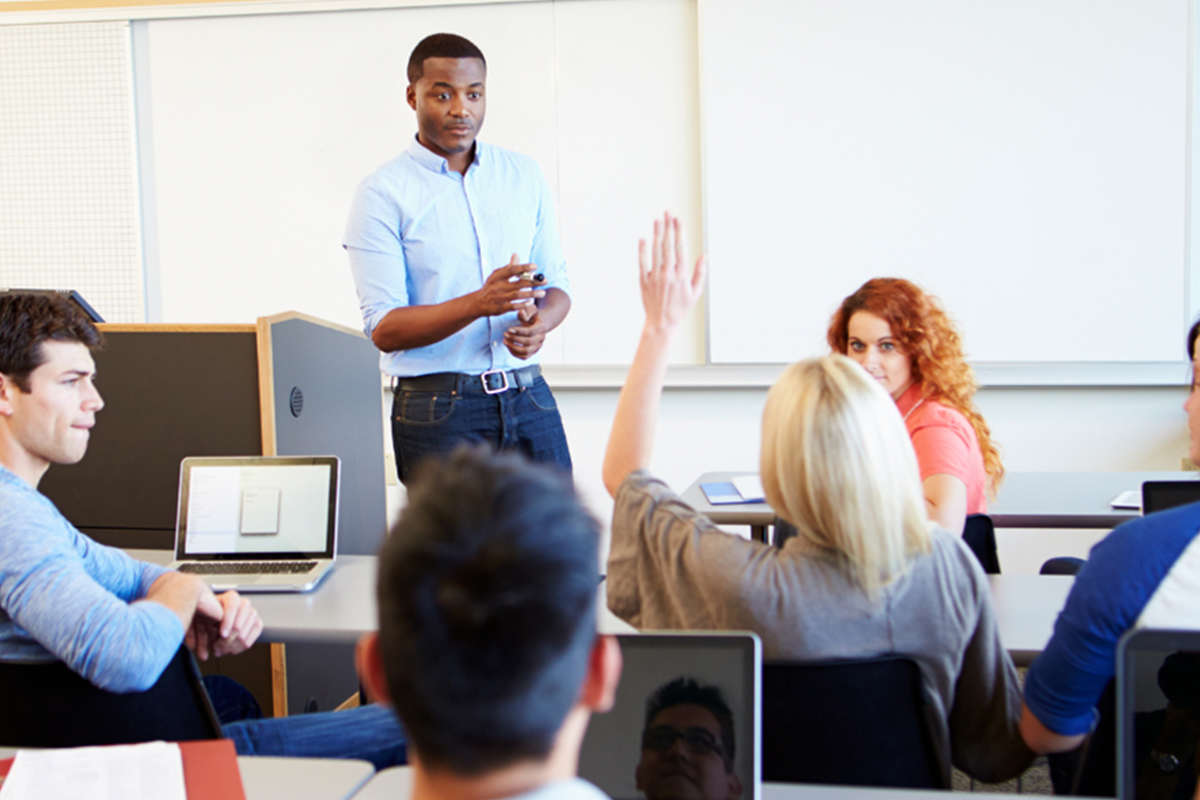 A young teacher in a classroom stood up answer questions