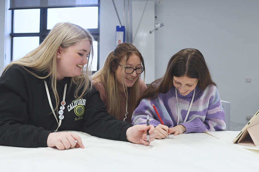 three students happily working together